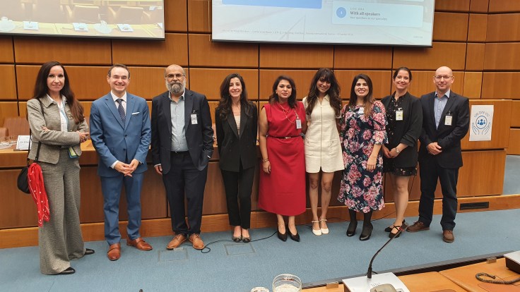 Members of the DIN ExCom and the Speakers of the Event standing in front of the podium of CR1 after the event.
